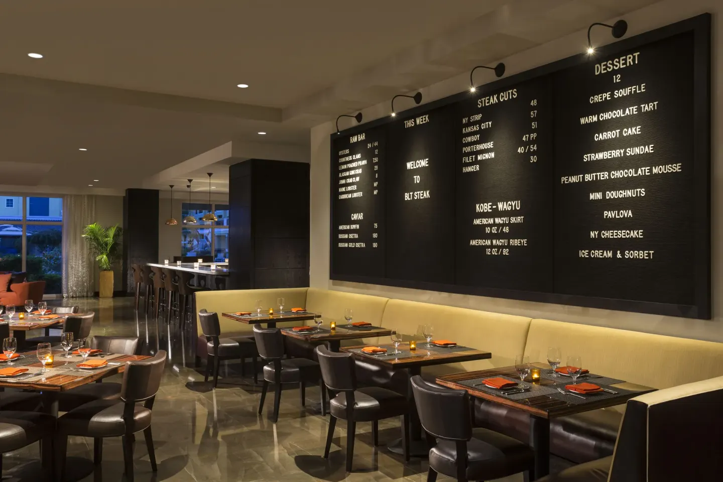 BLT Steak dining room with menu boards at The Ritz-Carlton, Aruba.