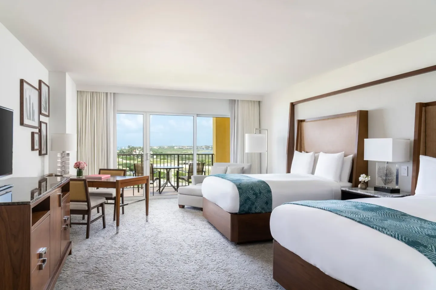 Coastline View guest room with two beds and balcony at The Ritz-Carlton, Aruba.
