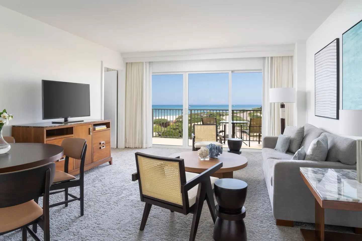 Junior Suite living area with balcony and coastline view at The Ritz-Carlton, Aruba.