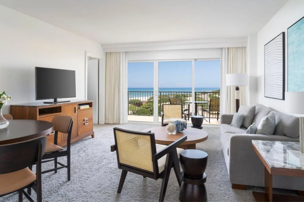 Junior Suite living area with balcony and ocean view at The Ritz-Carlton, Aruba.