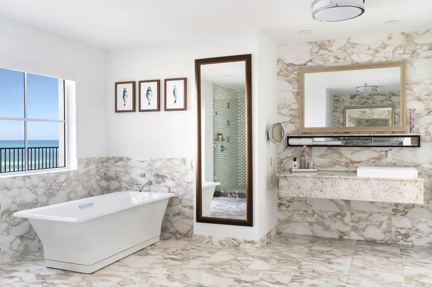 Presidential suite marble bathroom with soaking tub and ocean view at The Ritz-Carlton, Aruba.