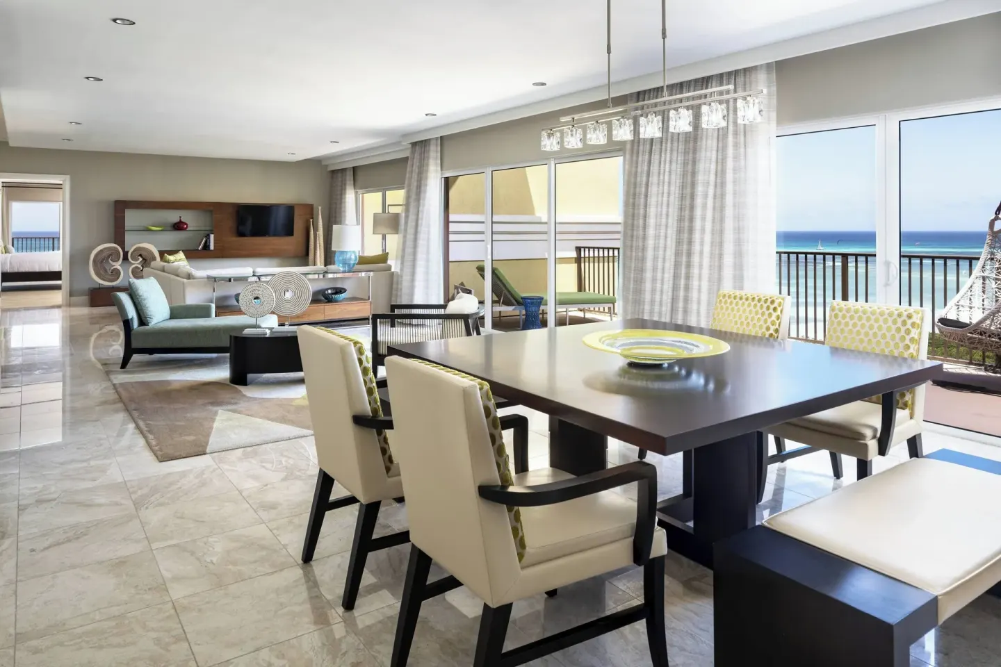 Presidential suite dining and living area with oceanfront balcony at The Ritz-Carlton, Aruba.