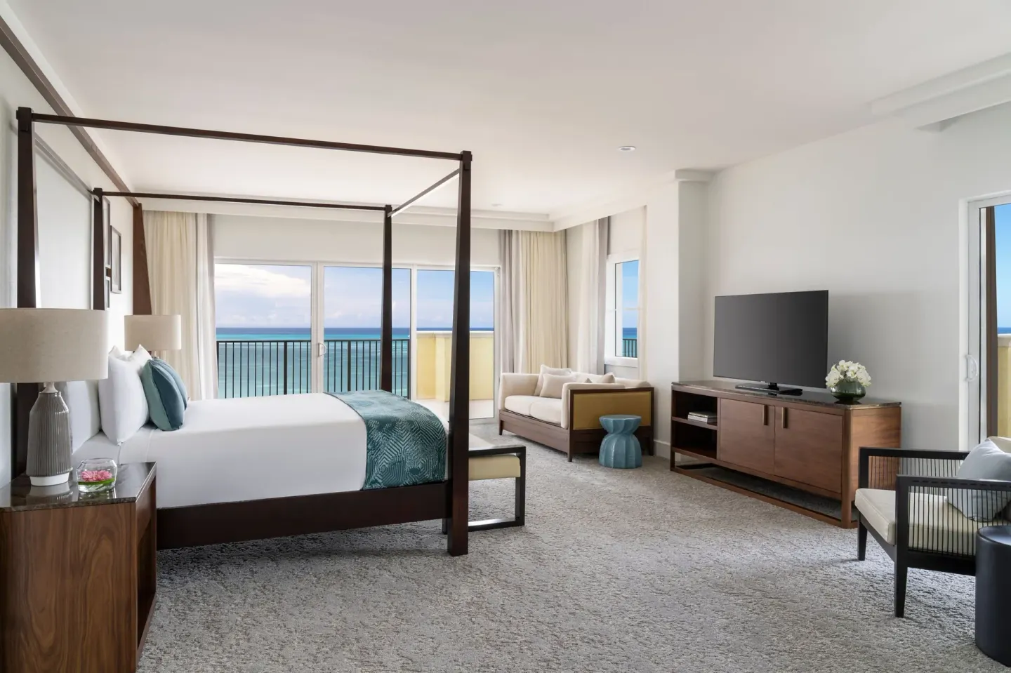 Presidential suite bedroom with a four-poster king bed and ocean view at The Ritz-Carlton, Aruba.