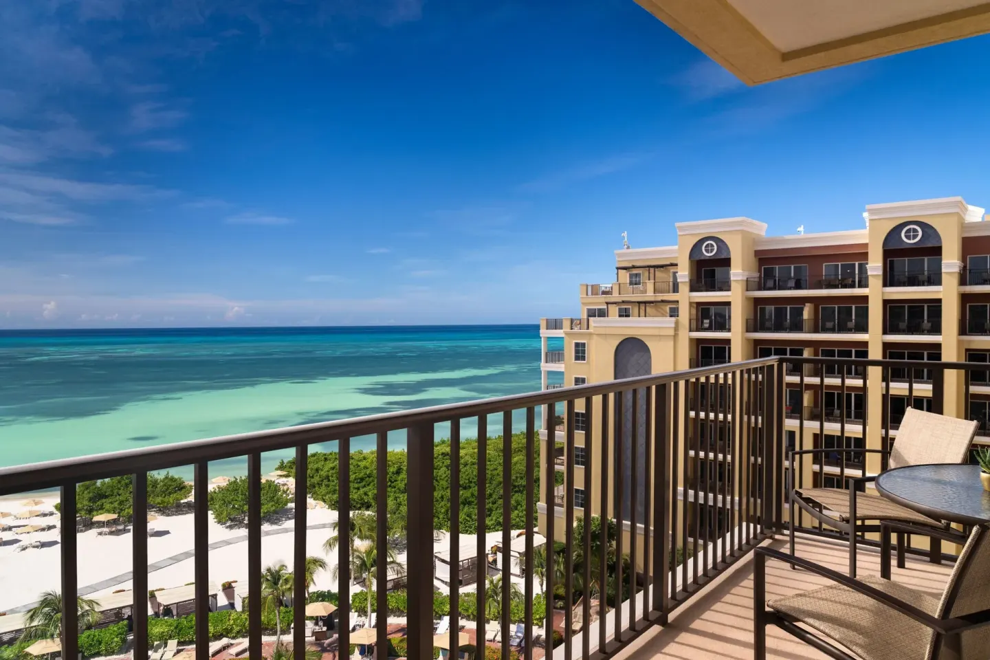 Oceanfront balcony view from a deluxe suite at The Ritz-Carlton, Aruba overlooking the beach and sea.