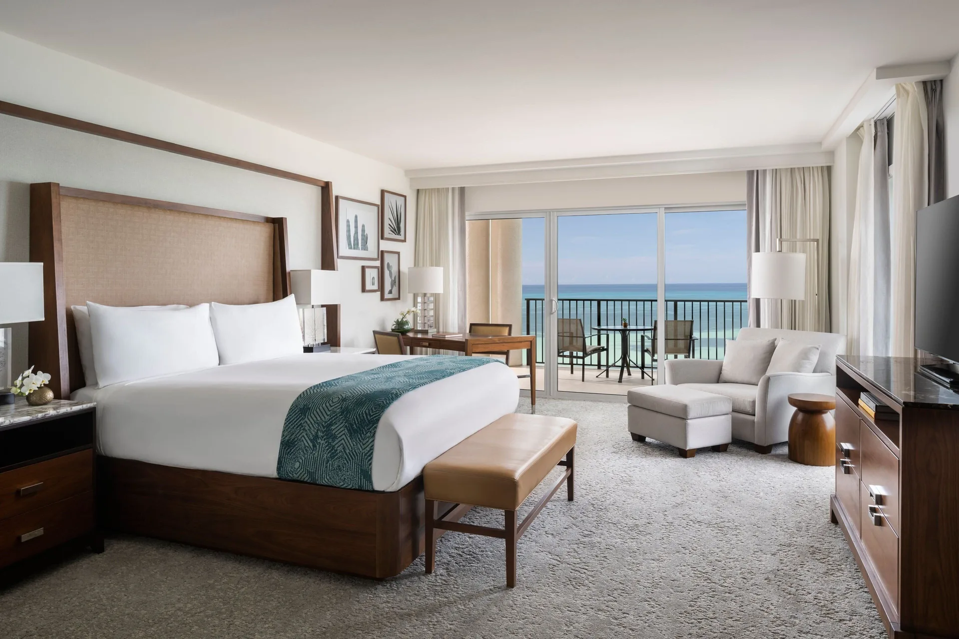 Ocean View Club Lounge Access 1-Bedroom Suite at The Ritz-Carlton, Aruba with king Bed, elegant living area, and Caribbean Sea views from Palm Beach.