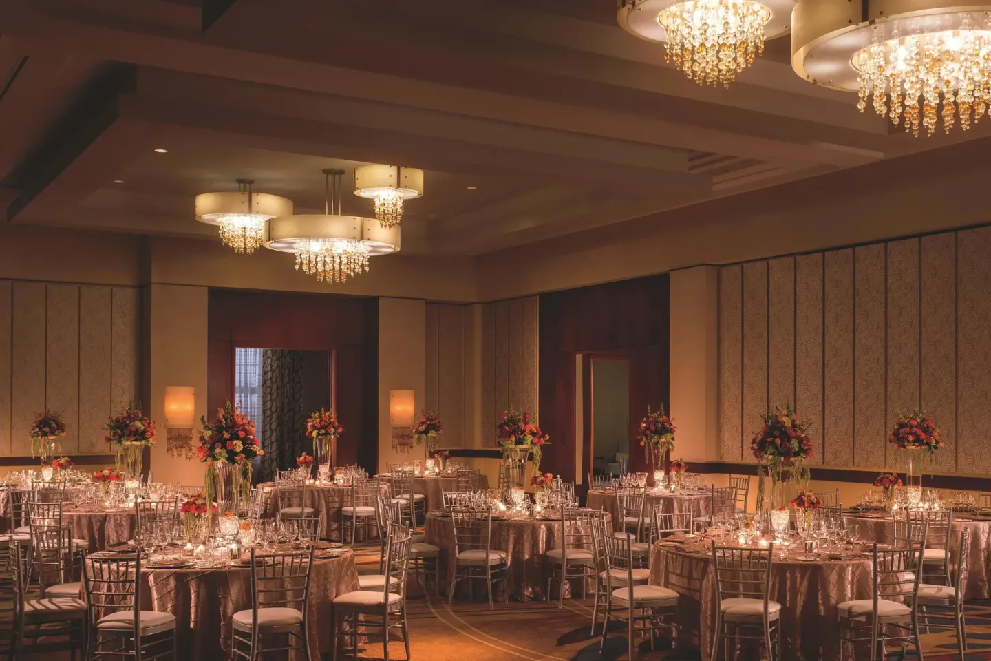Ballroom dinner setup with round tables and floral centerpieces at The Ritz-Carlton, Aruba.