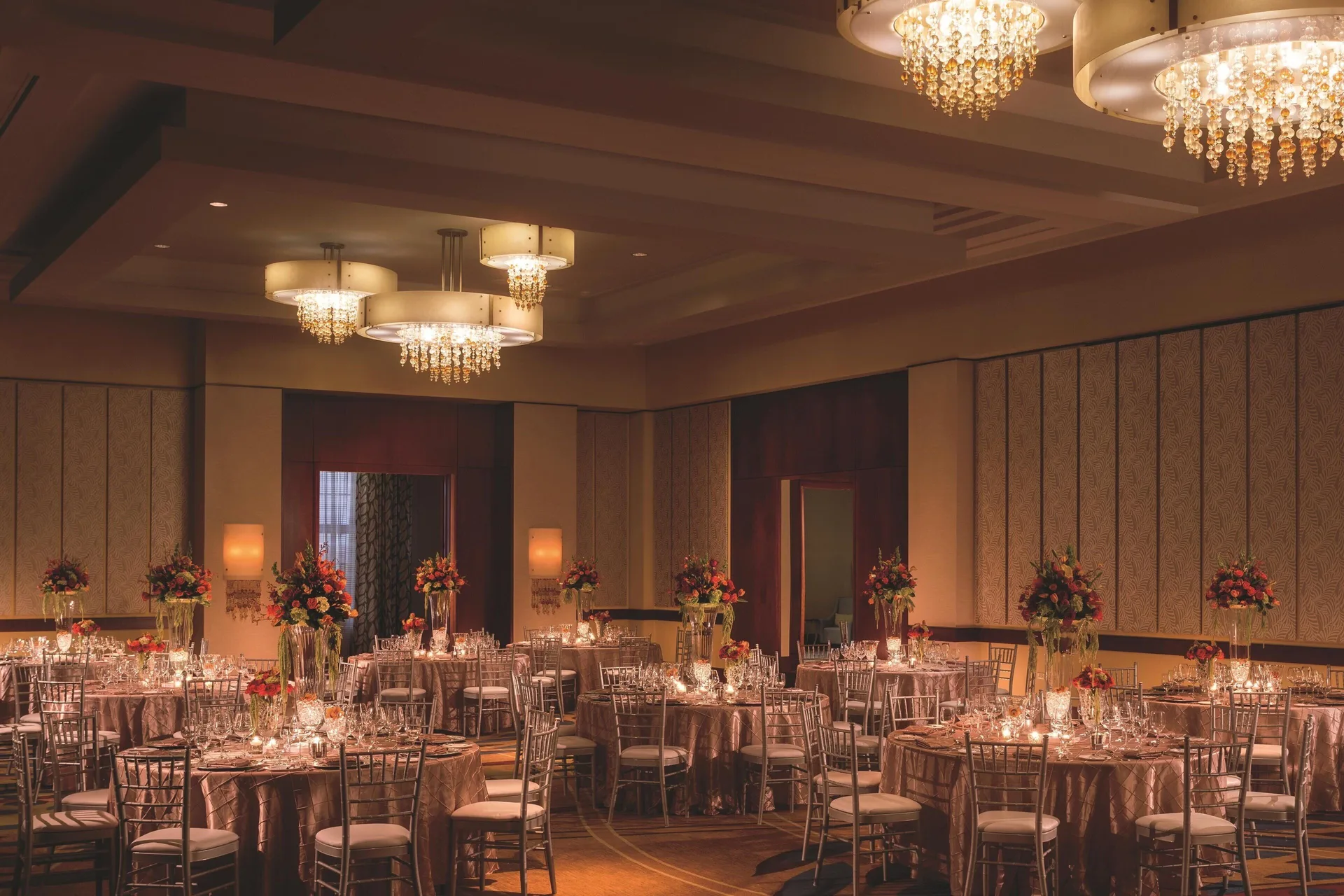 Ballroom dinner setup with round tables and floral centerpieces at The Ritz-Carlton, Aruba.