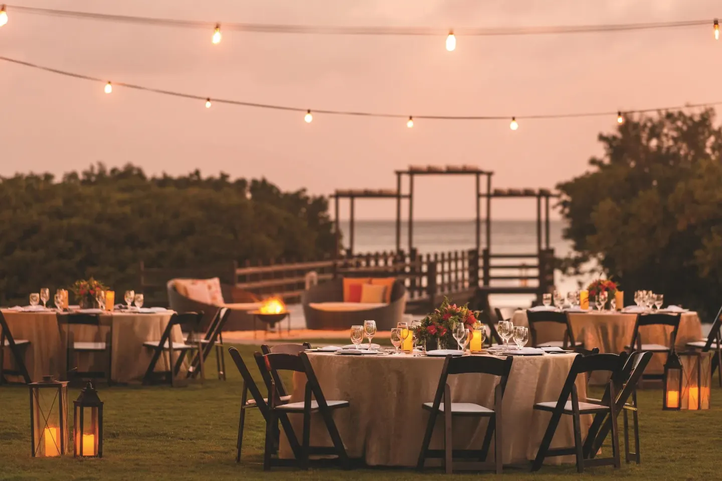 Outdoor event tables on a lawn near the beach at The Ritz-Carlton, Aruba.