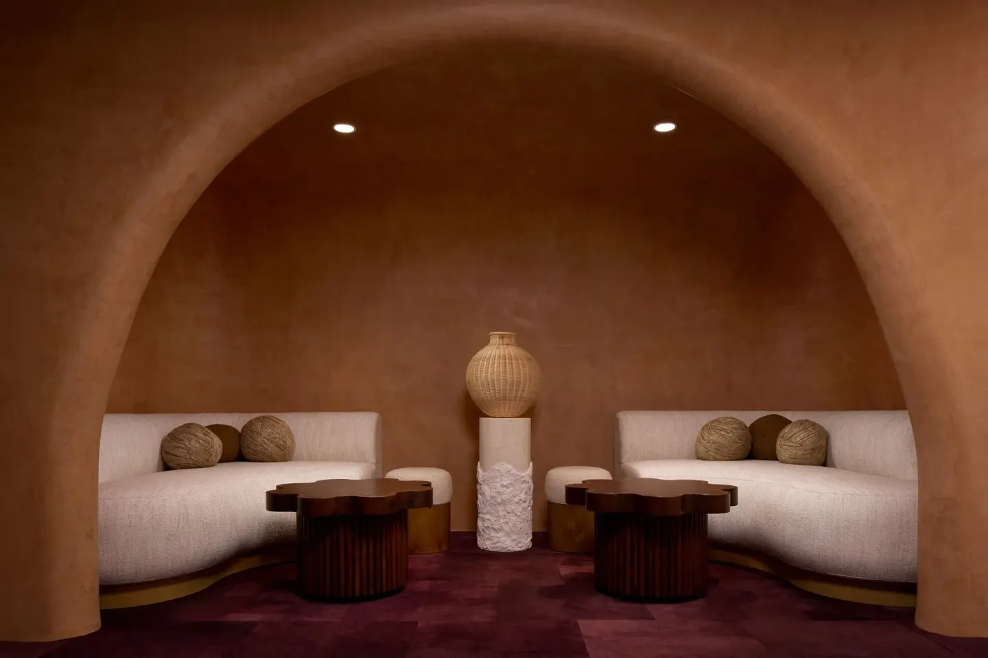 Arched lounge alcove with curved sofas at The Ritz-Carlton, Grand Cayman.