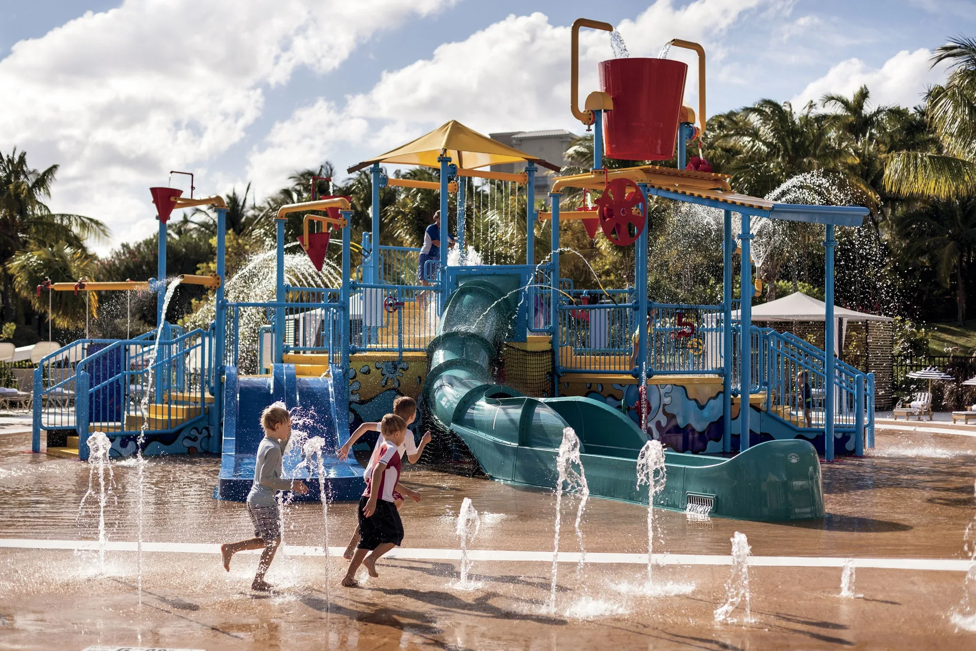 Children run through a colorful splash playground at The Ritz-Carlton, Grand Cayman.