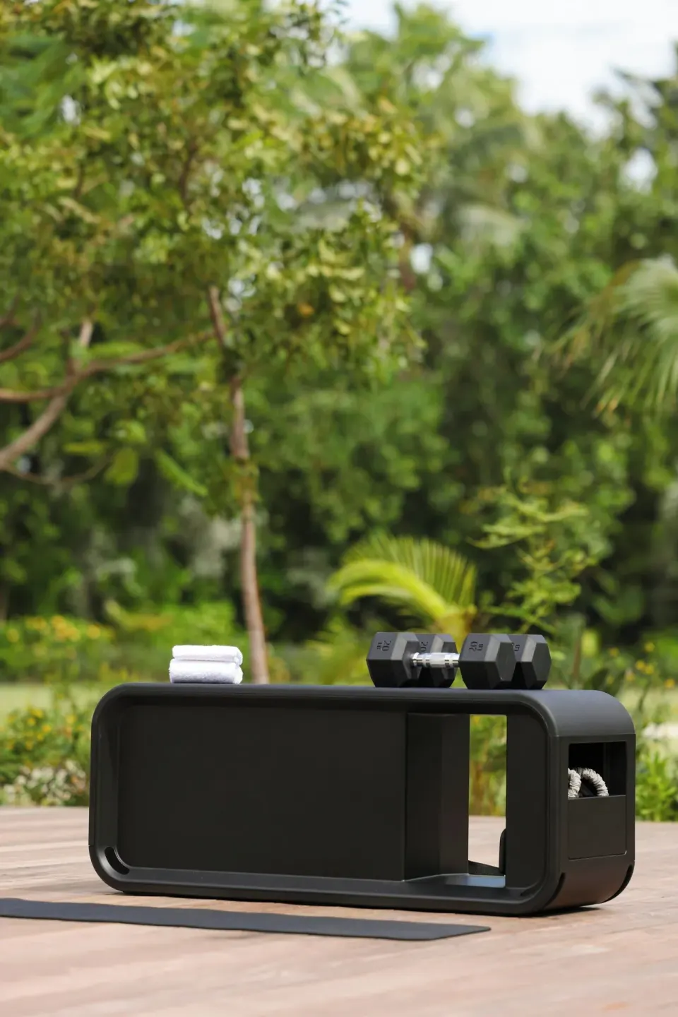 Outdoor fitness bench with dumbbells and towels at The Ritz-Carlton, Grand Cayman.