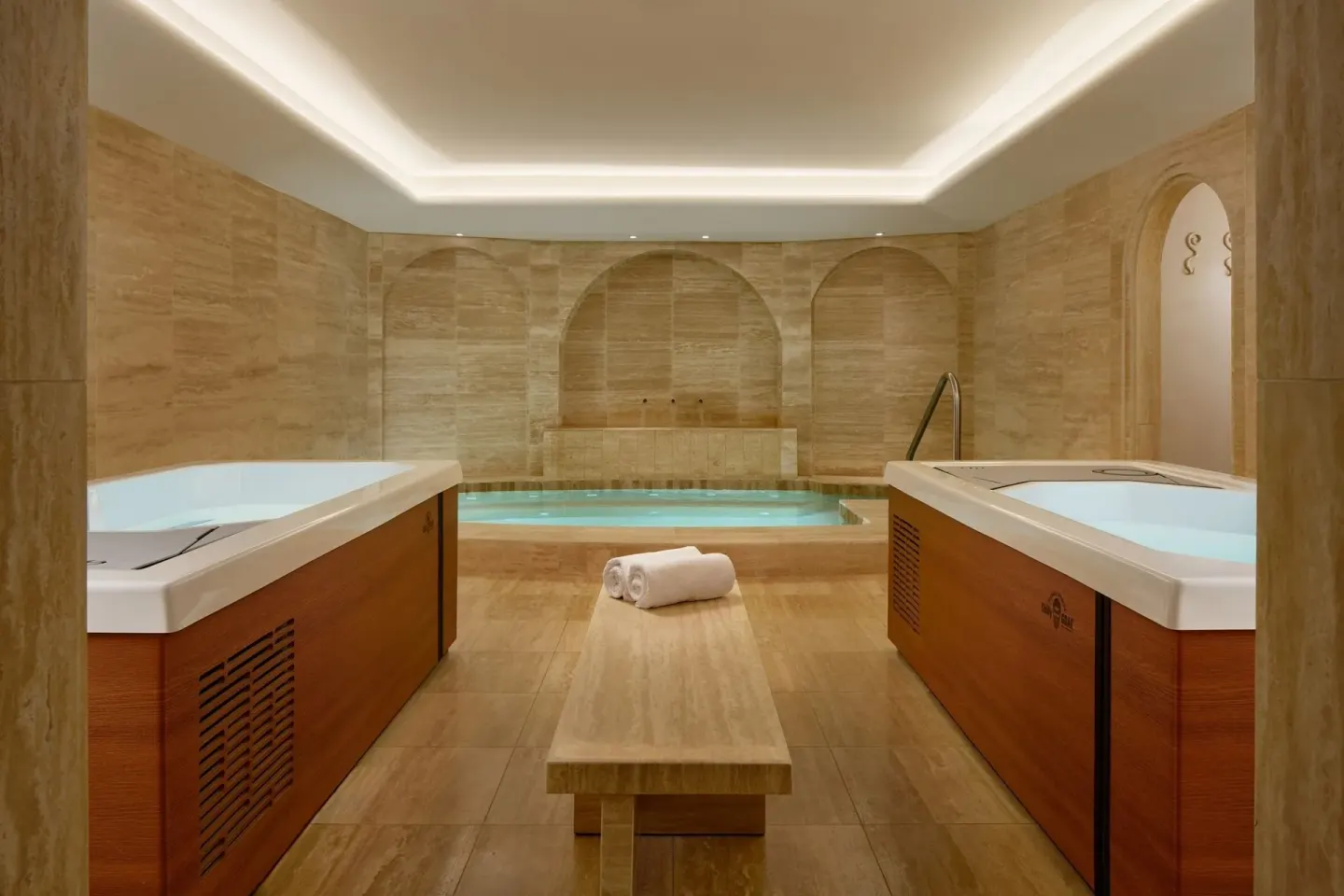 Spa pool room with plunge tubs and a towel at The Ritz-Carlton, Grand Cayman.