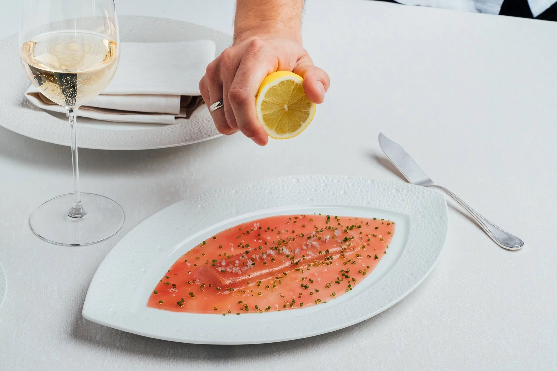 A lemon is squeezed over a seafood dish at The Ritz-Carlton, Grand Cayman.