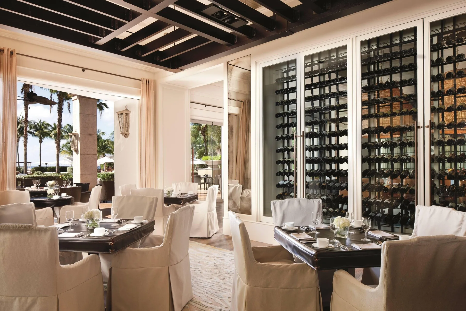 An elegant dining room with wine storage is shown at The Ritz-Carlton, Grand Cayman.