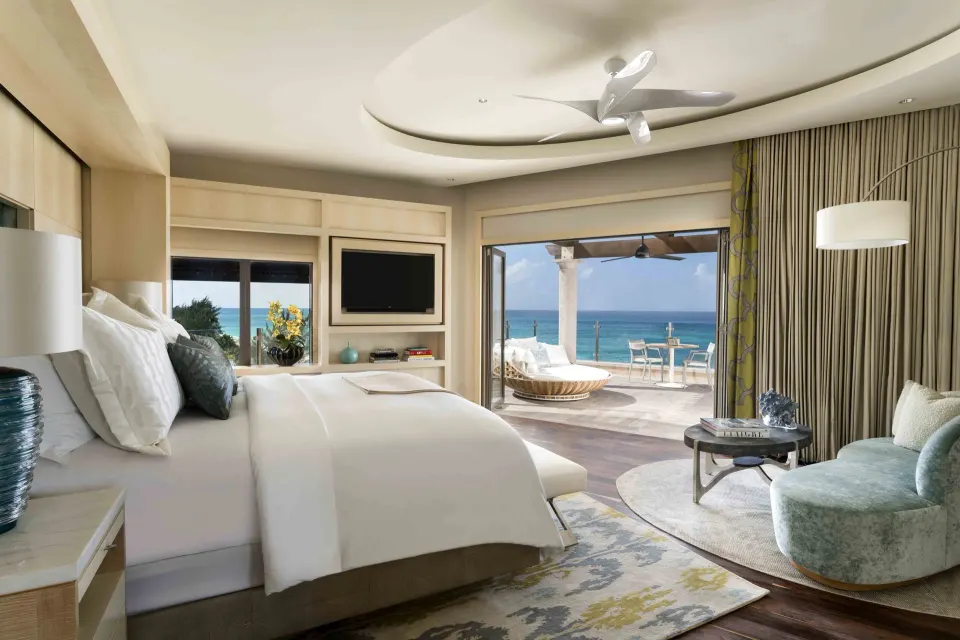 Grand Suite bedroom with king bed and oceanfront terrace at The Ritz-Carlton, Grand Cayman.