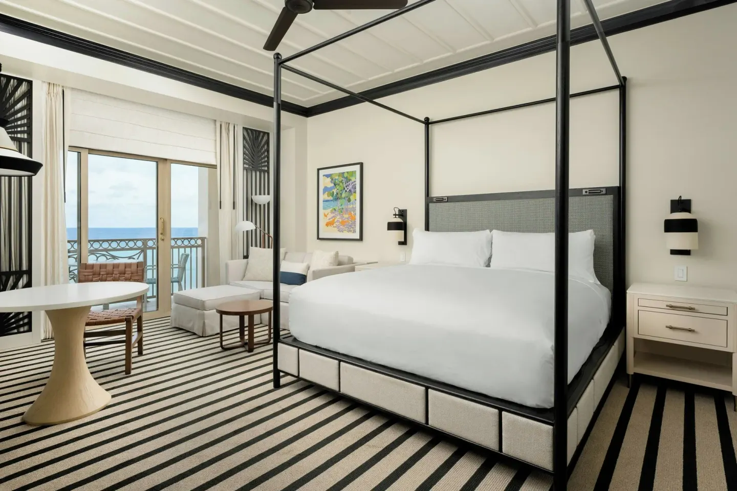 Four-poster king bed and oceanfront balcony at The Ritz-Carlton, Grand Cayman.