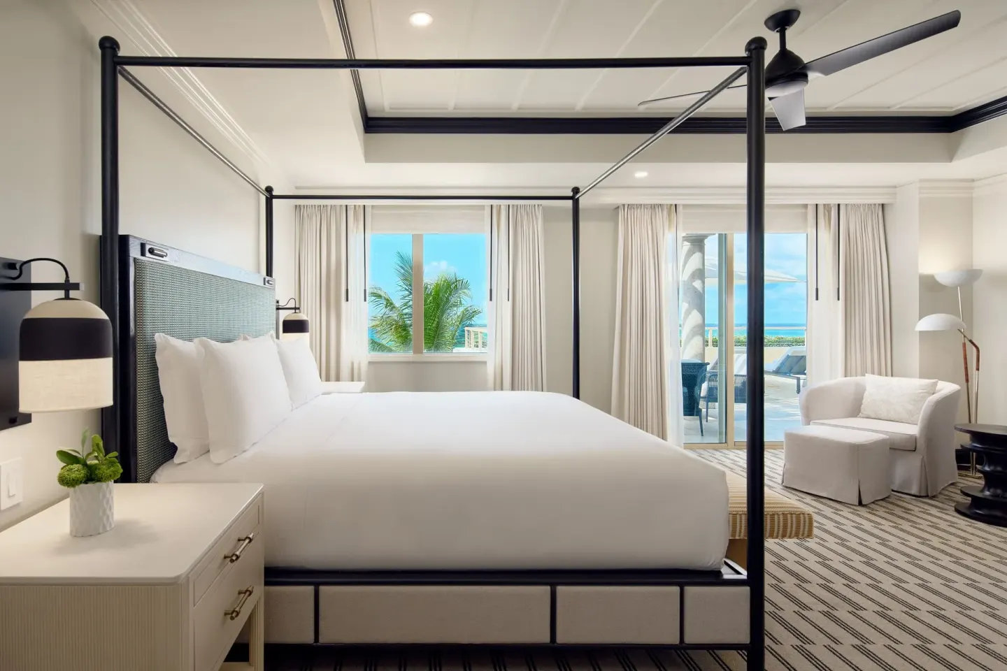 Oceanfront guest room with king bed and balcony at The Ritz-Carlton, Grand Cayman.