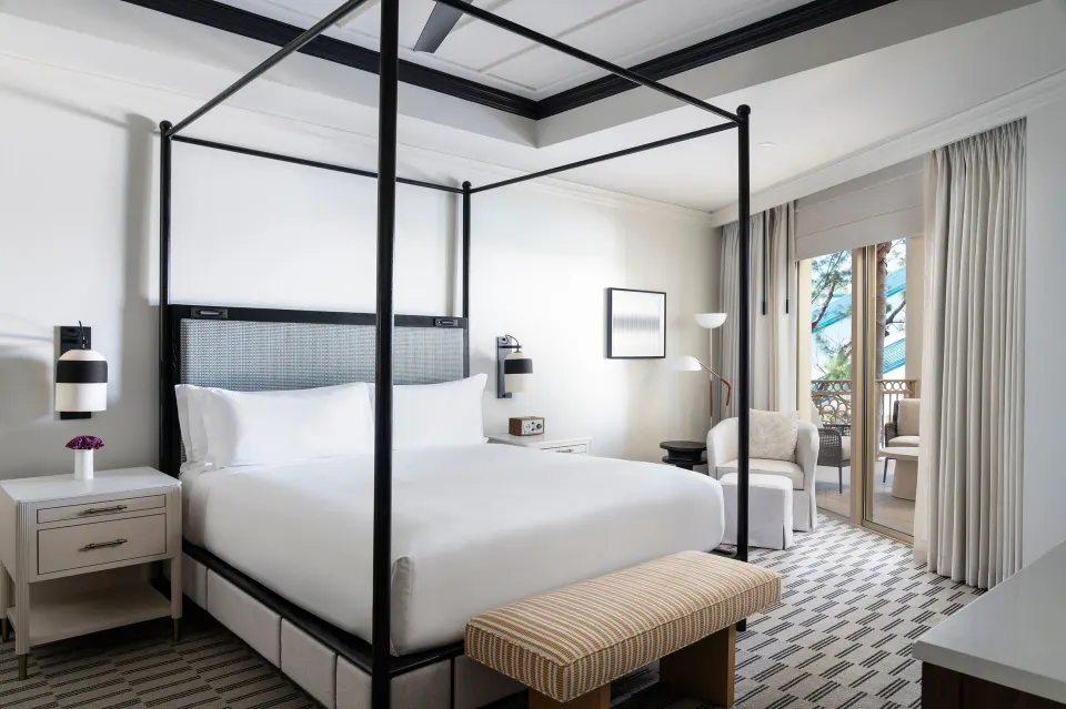 King bedroom with balcony doors in a resort-view suite at The Ritz-Carlton, Grand Cayman.