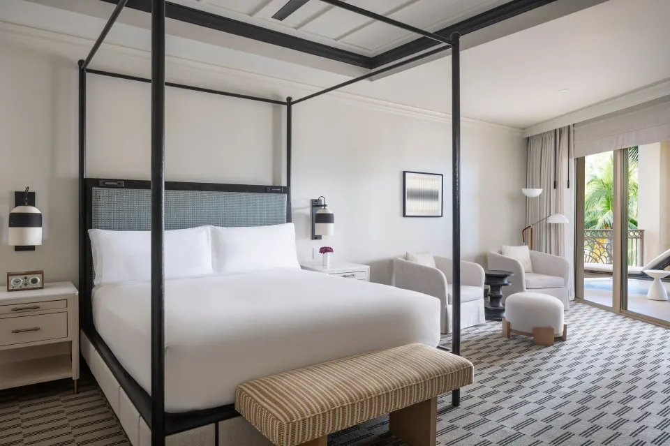 Four-poster king bedroom in a resort-view suite at The Ritz-Carlton, Grand Cayman.