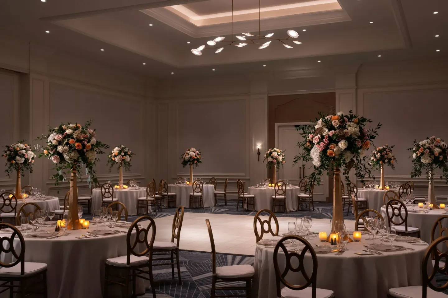 Ballroom dinner tables with tall floral centerpieces at The Ritz-Carlton, Grand Cayman.