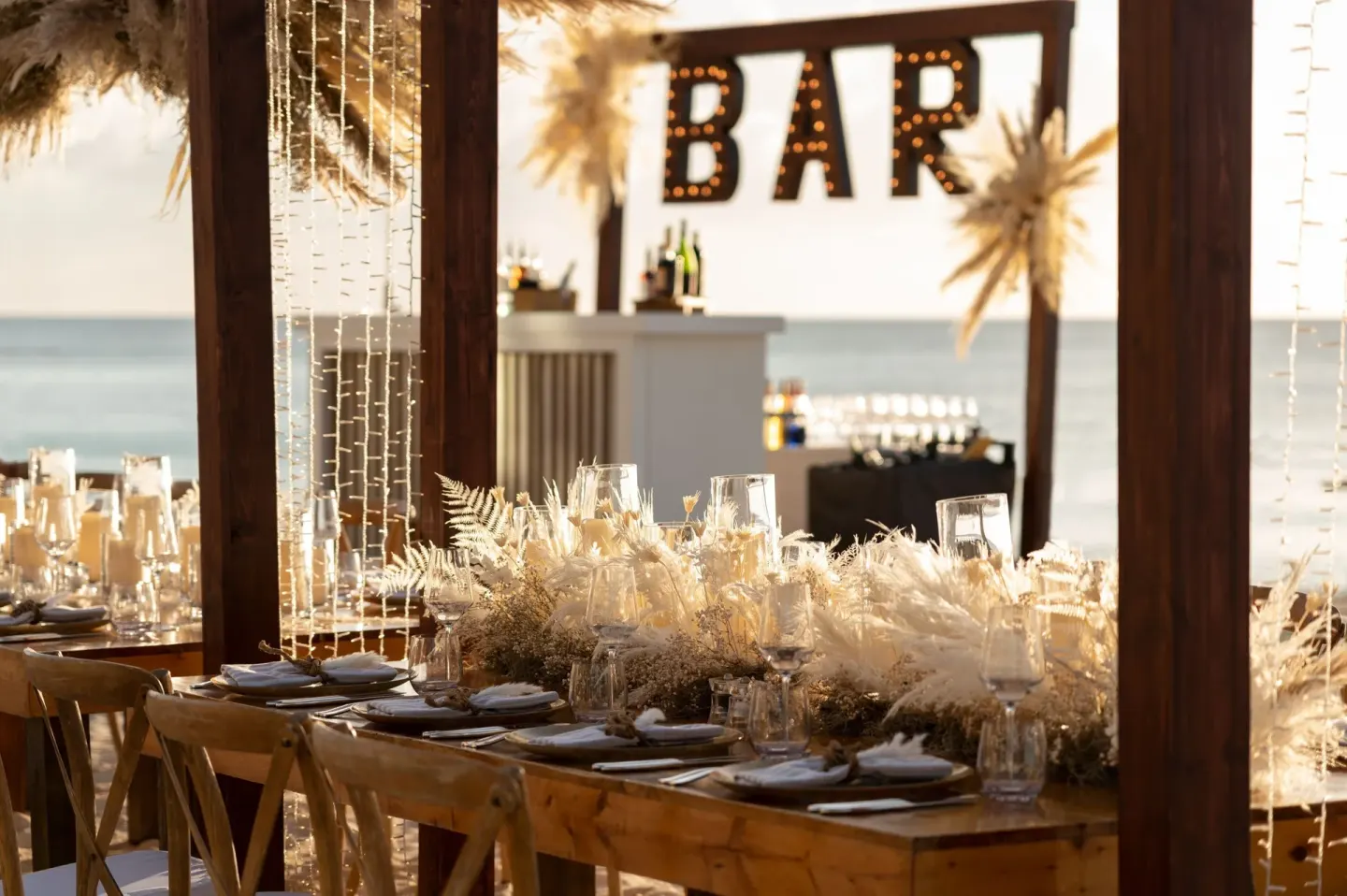 Beachside event table and bar setup at The Ritz-Carlton, Grand Cayman.