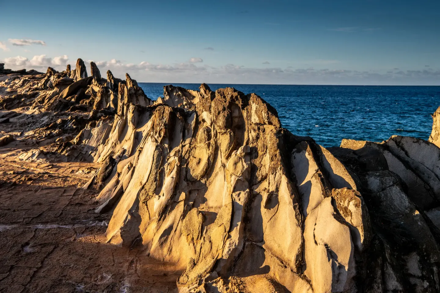 Jagged coastal rocks beside the ocean near The Ritz-Carlton Maui, Kapalua.