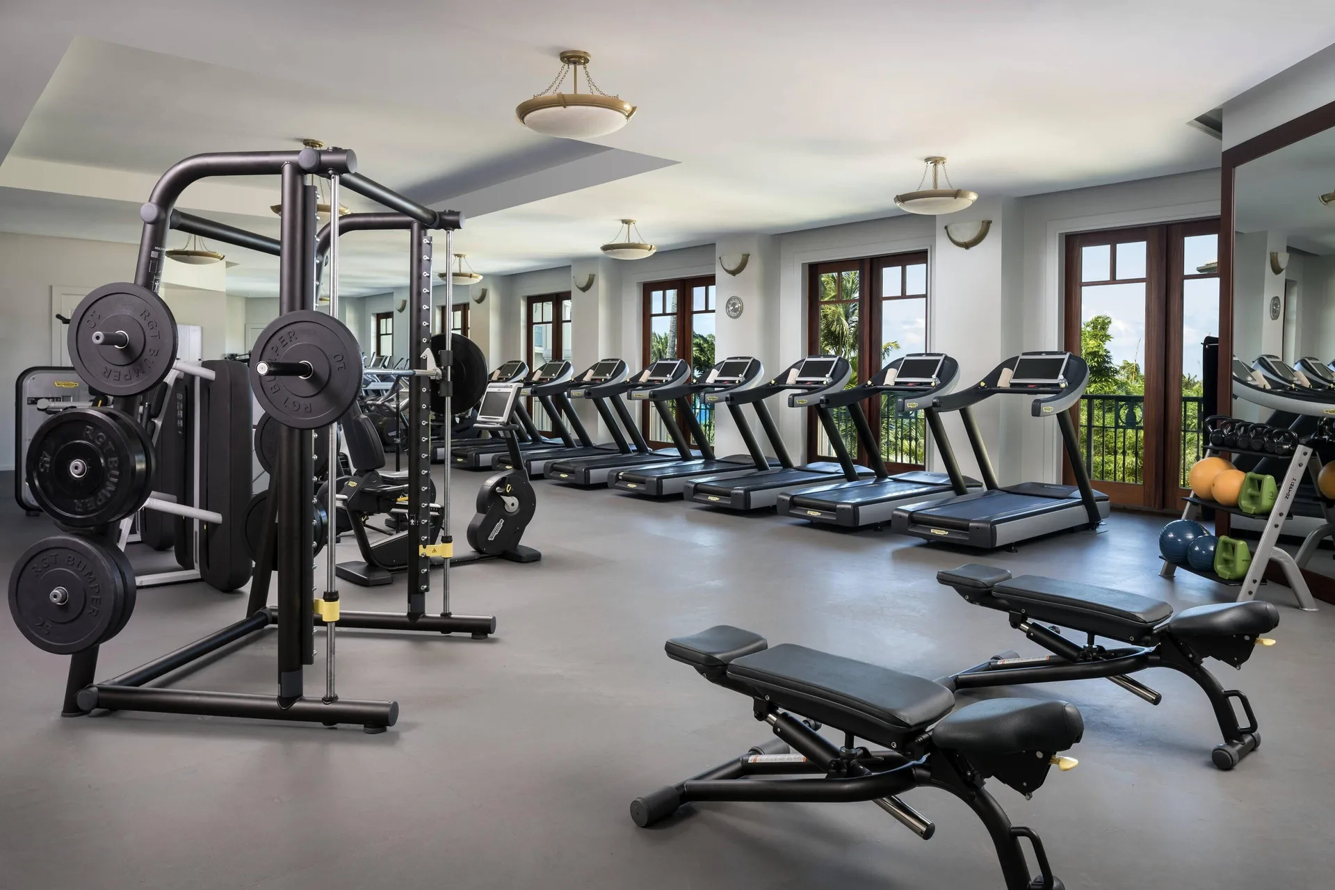 Fitness center with treadmills, weights, and benches at The Ritz-Carlton Maui, Kapalua.