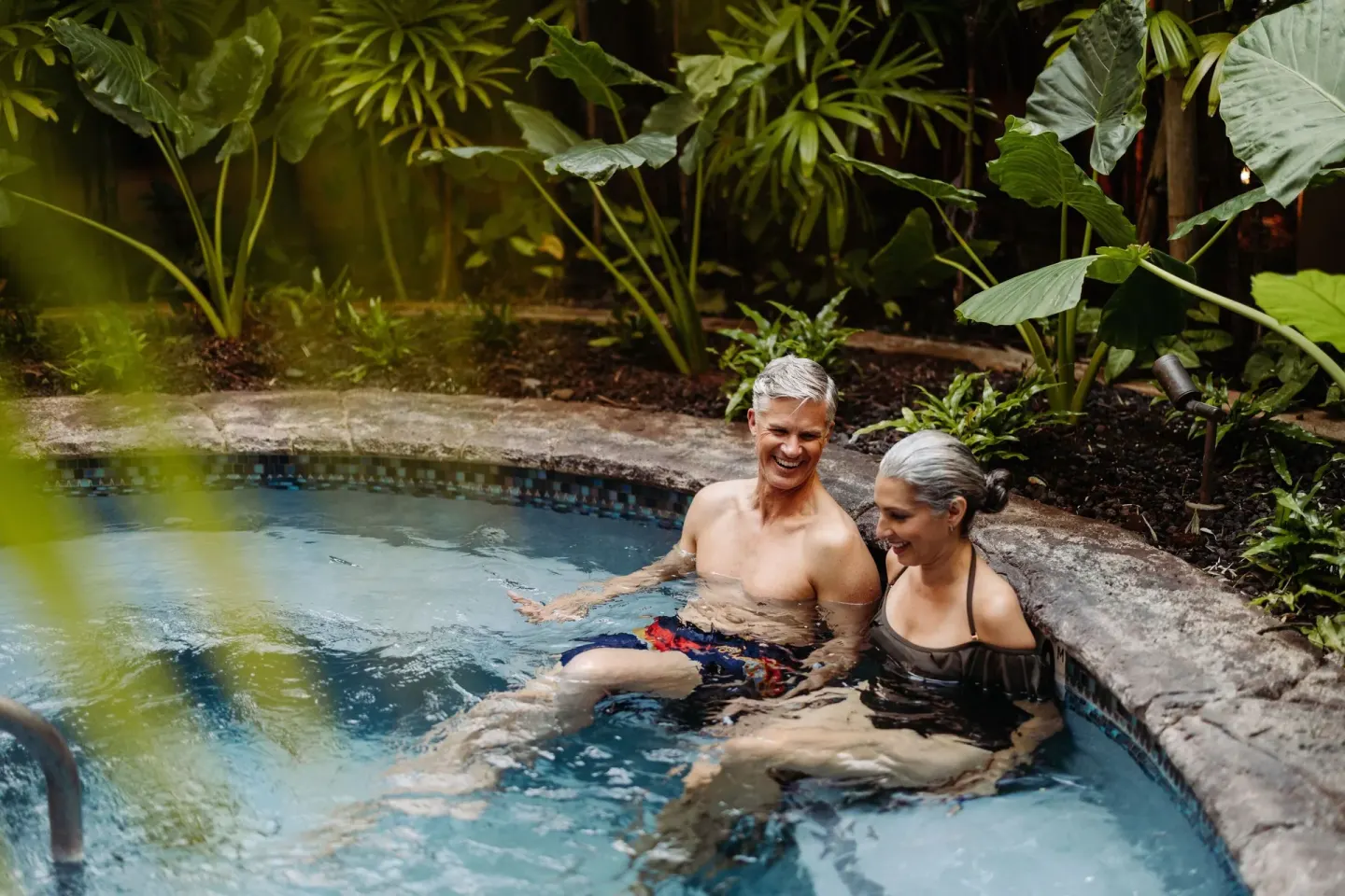 Couple relaxing in a garden hot tub at The Ritz-Carlton Maui, Kapalua.