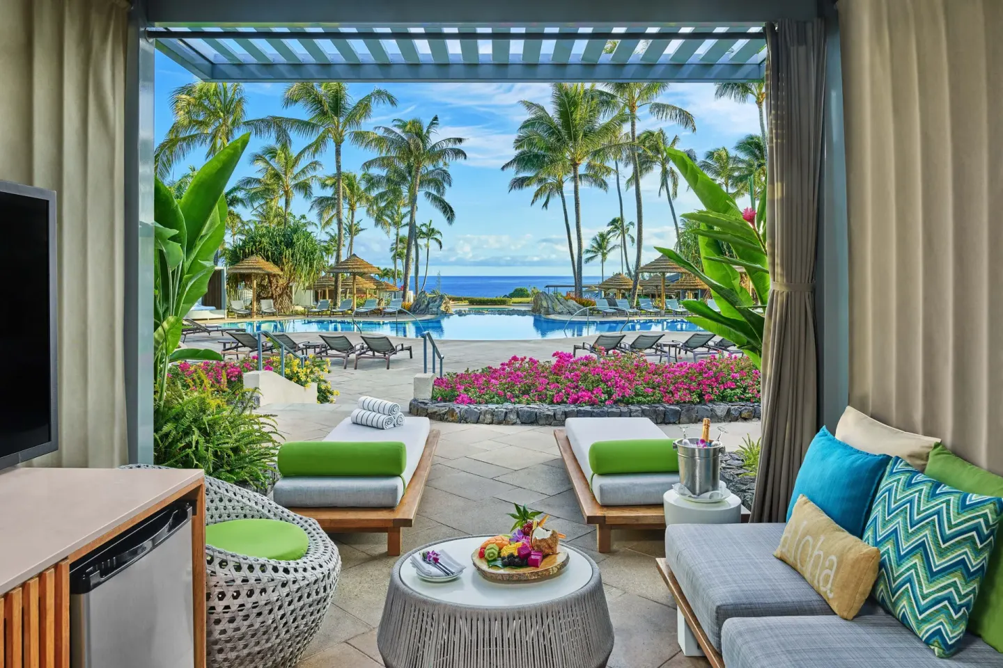 Poolside cabana with daybeds overlooking the pool and ocean at The Ritz-Carlton Maui, Kapalua.