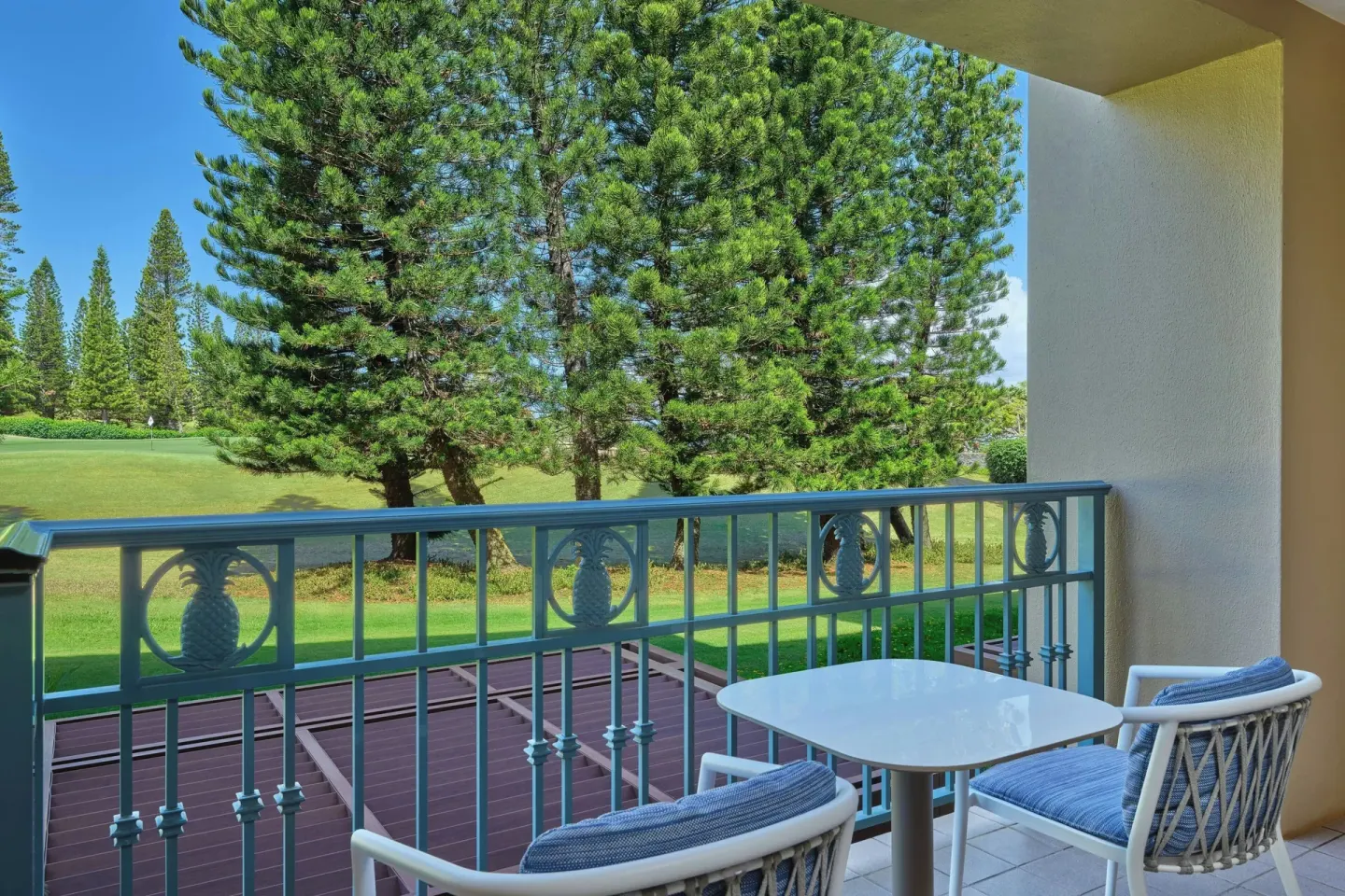 Garden-view balcony seating for a one-bedroom residential suite at The Ritz-Carlton Maui, Kapalua.