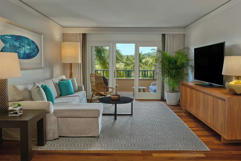 Residential suite living room with sofa bed and balcony at The Ritz-Carlton Maui, Kapalua.