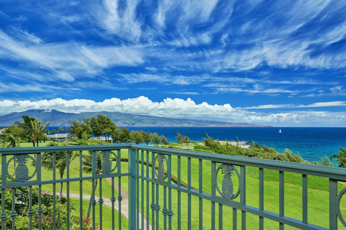 Club Room balcony view of lawn, ocean, and distant island at The Ritz-Carlton Maui, Kapalua.