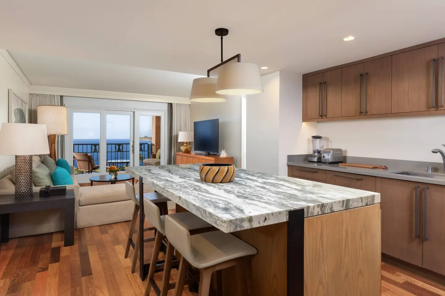 Club Room kitchen and living area with ocean-view balcony at The Ritz-Carlton Maui, Kapalua.