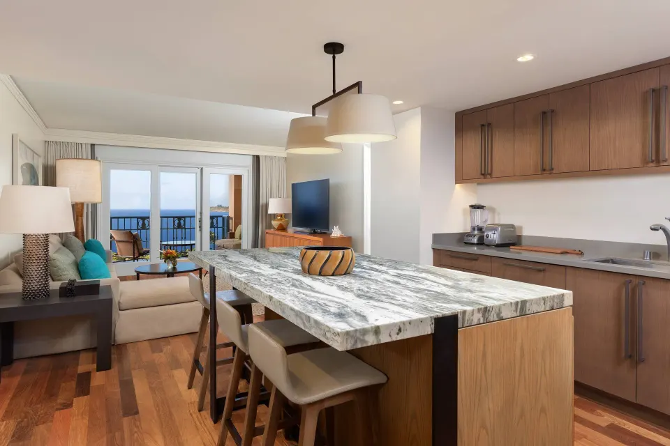 Club Room kitchen and living area with ocean-view balcony at The Ritz-Carlton Maui, Kapalua.