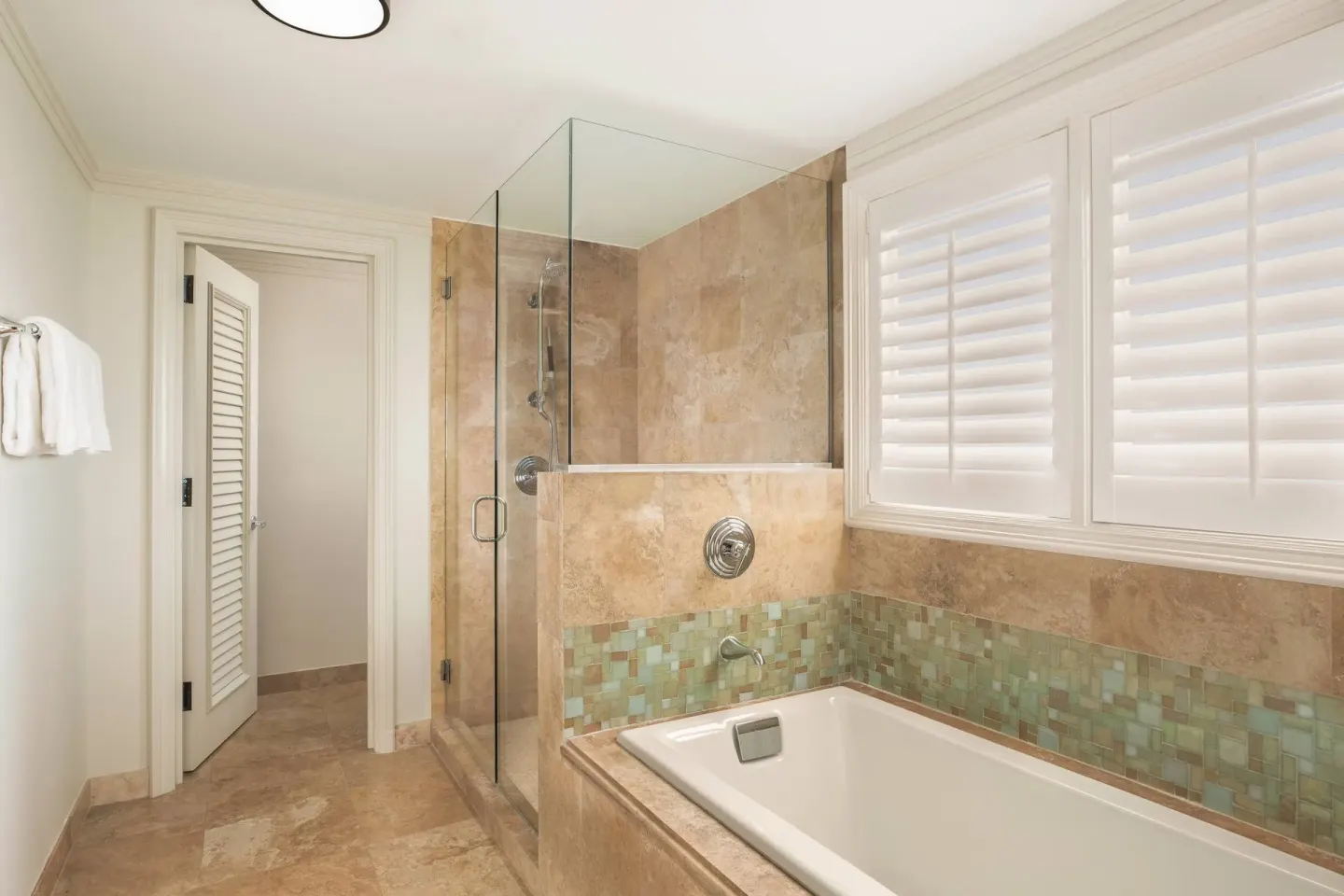 Royal Suite Oceanfront bathroom tub and glass shower at The Ritz-Carlton Maui, Kapalua.