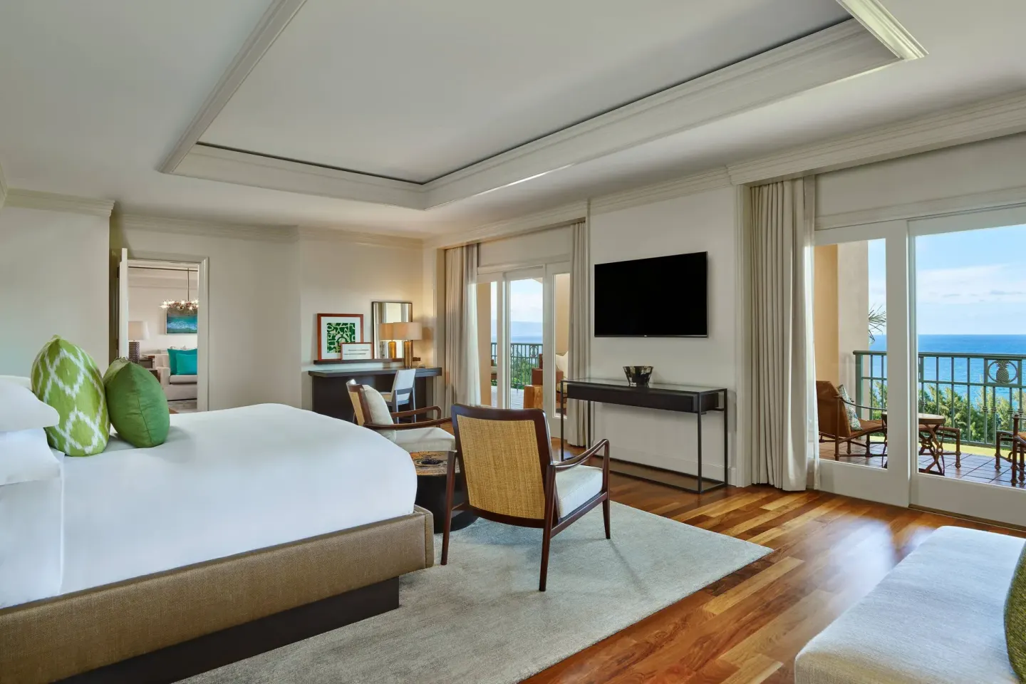 Royal Suite Oceanfront bedroom at The Ritz-Carlton Maui, Kapalua with a king bed and balcony doors.