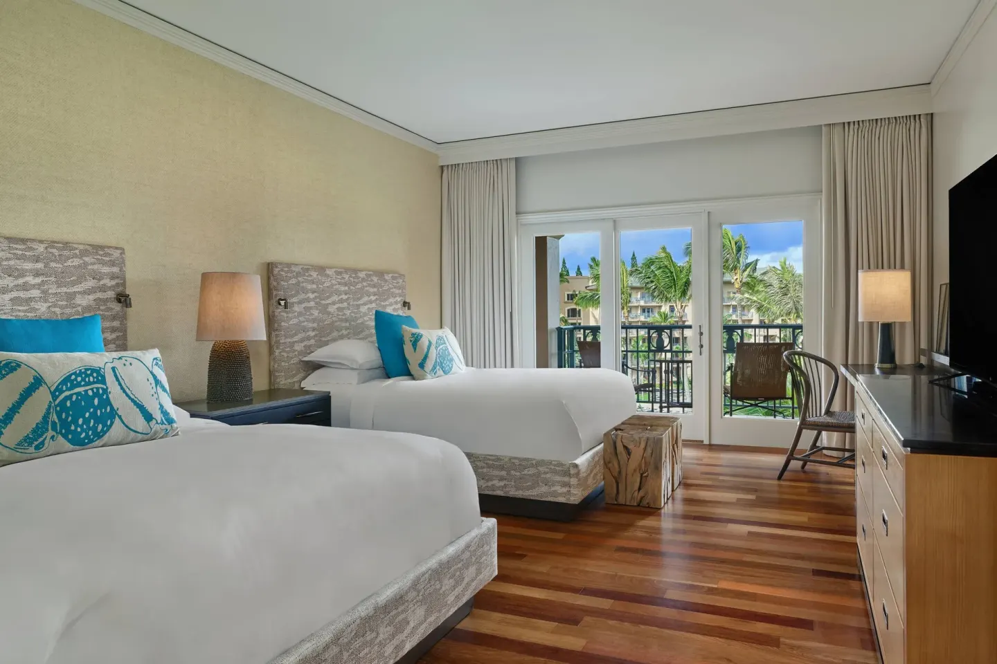 Two-bed suite bedroom with balcony and garden view at The Ritz-Carlton Maui, Kapalua.