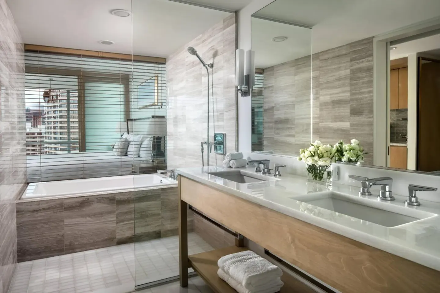 Bathroom with double vanity and glass shower at The Ritz-Carlton Residences, Waikiki Beach.