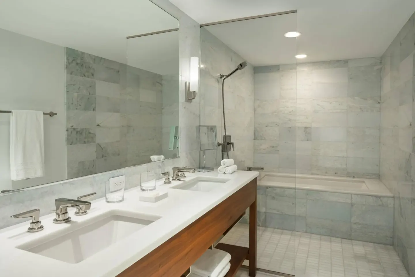 Bathroom vanity and bathtub with glass shower screen at The Ritz-Carlton Residences, Waikiki Beach.