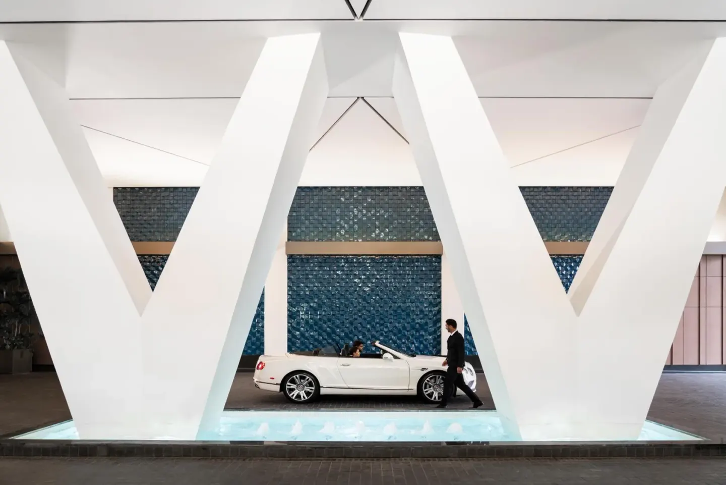 Covered arrival area with white structural columns at The Ritz-Carlton Residences, Waikiki Beach.