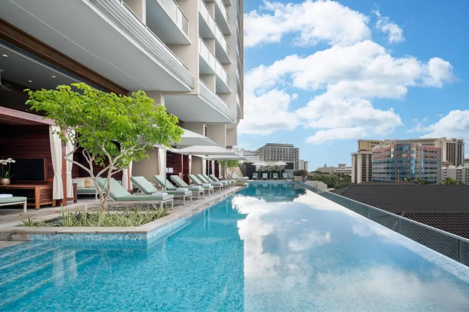 Infinity pool with cabanas and city views at The Ritz-Carlton Residences, Waikiki Beach.