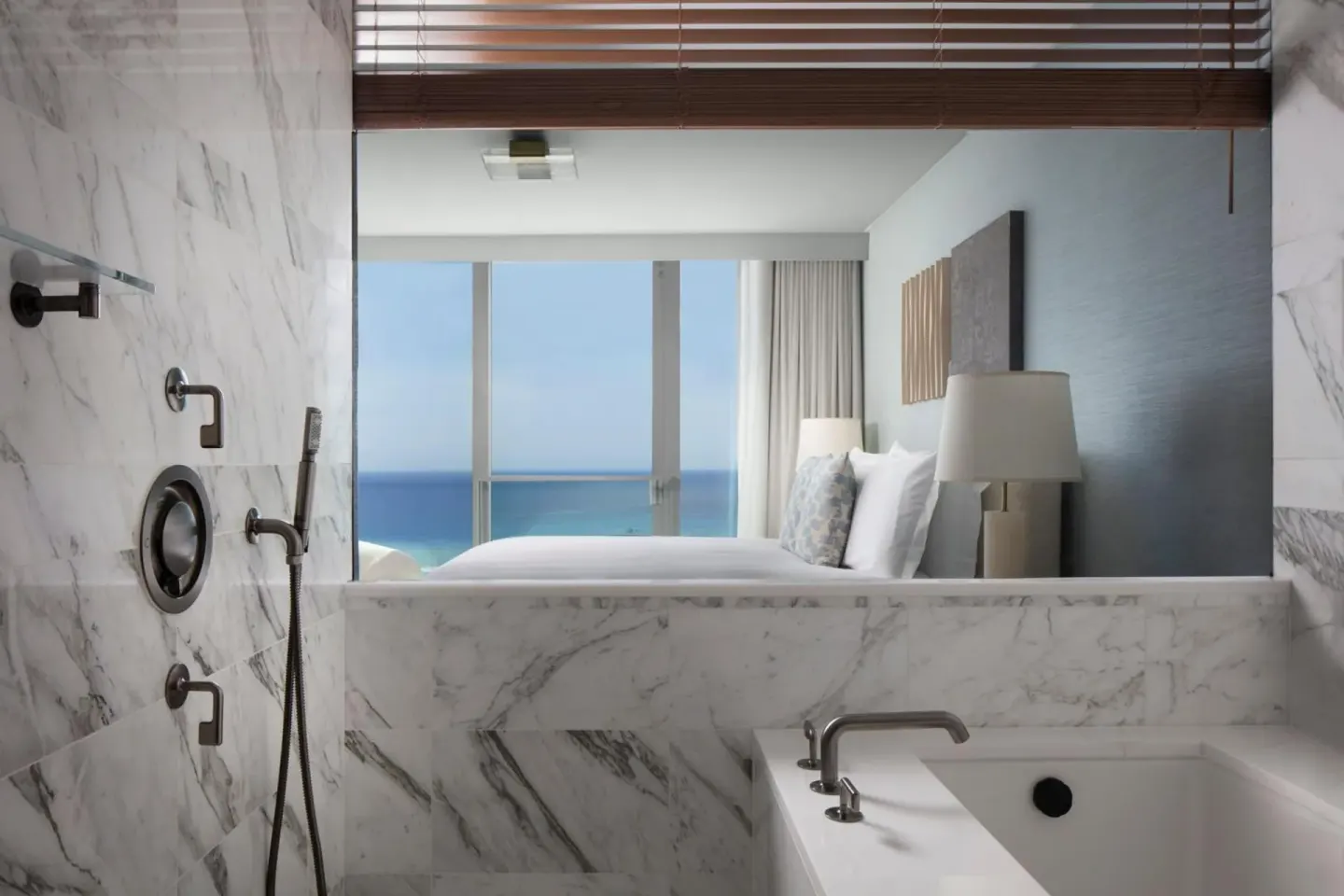 Marble bath looking into an ocean-view bedroom at The Ritz-Carlton Residences, Waikiki Beach.