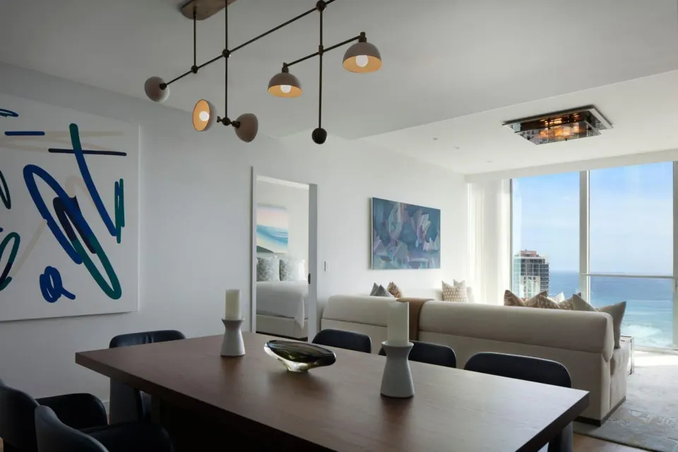 Dining and living area with ocean-facing windows at The Ritz-Carlton Residences, Waikiki Beach.