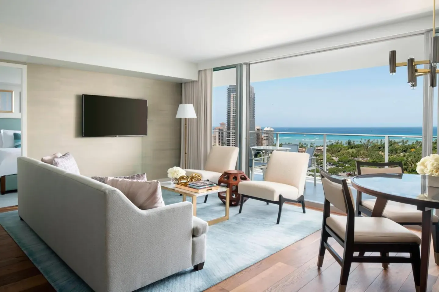 Suite living room with balcony and ocean view at The Ritz-Carlton Residences, Waikiki Beach.