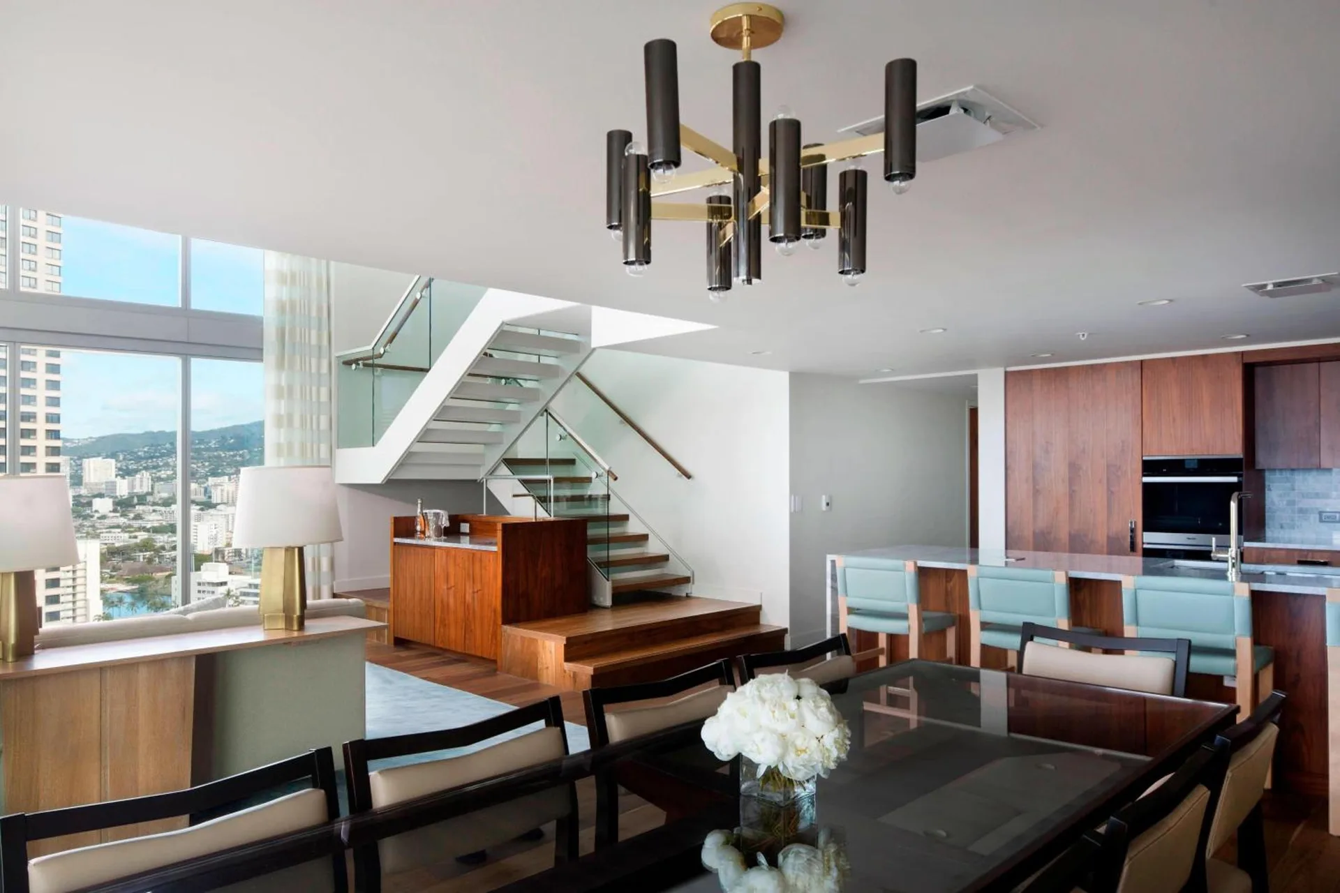 Penthouse dining area, kitchen, and staircase at The Ritz-Carlton Residences, Waikiki Beach.
