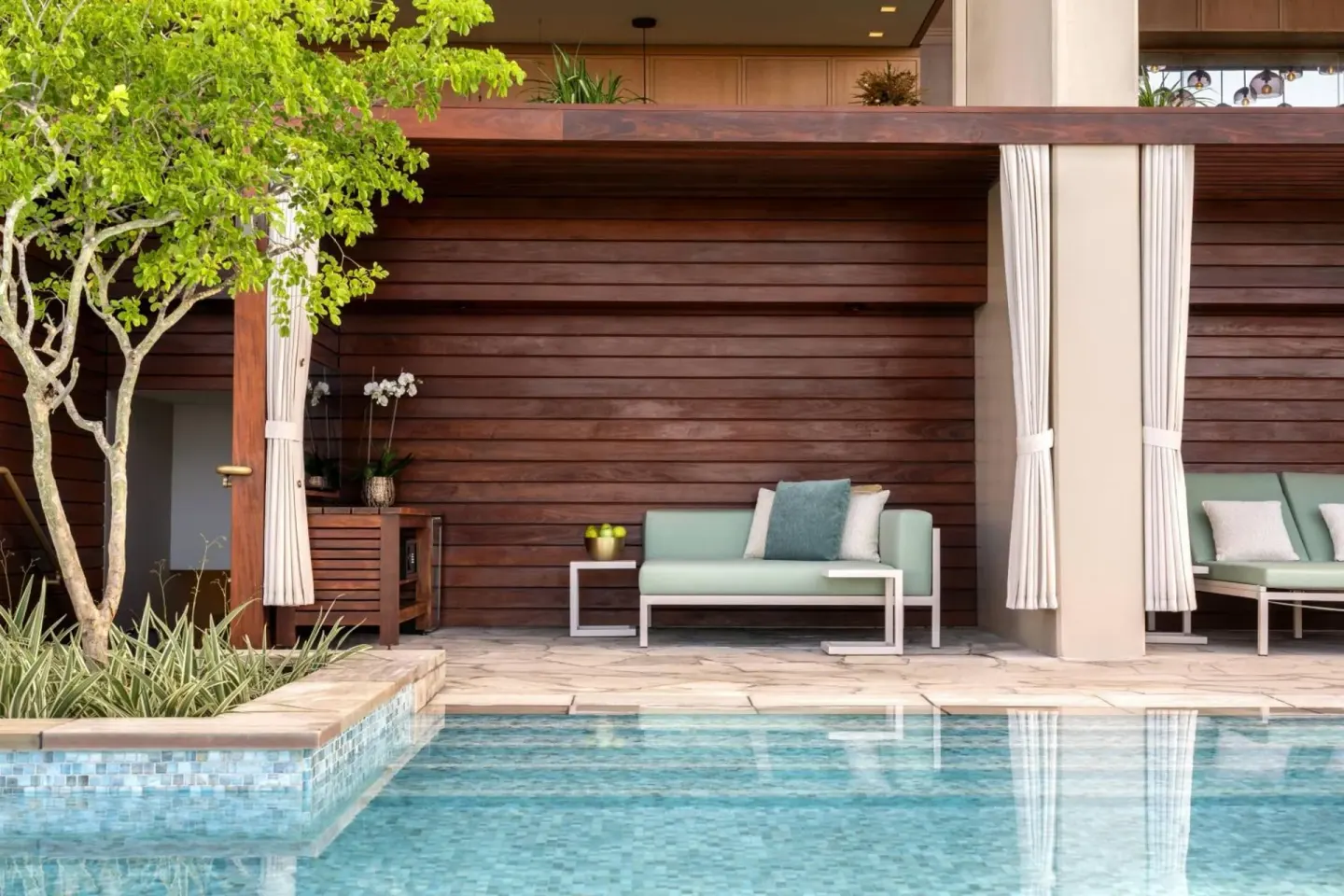 Poolside cabanas and lounge seating at The Ritz-Carlton Residences, Waikiki Beach.