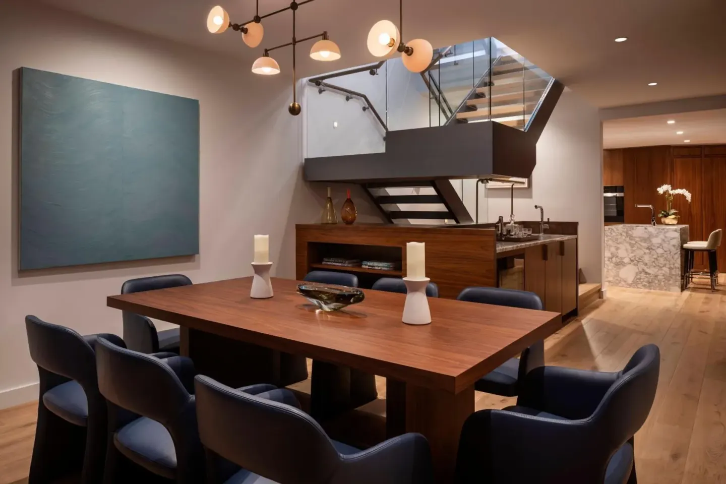 Dining area with staircase and open kitchen at The Ritz-Carlton Residences, Waikiki Beach.