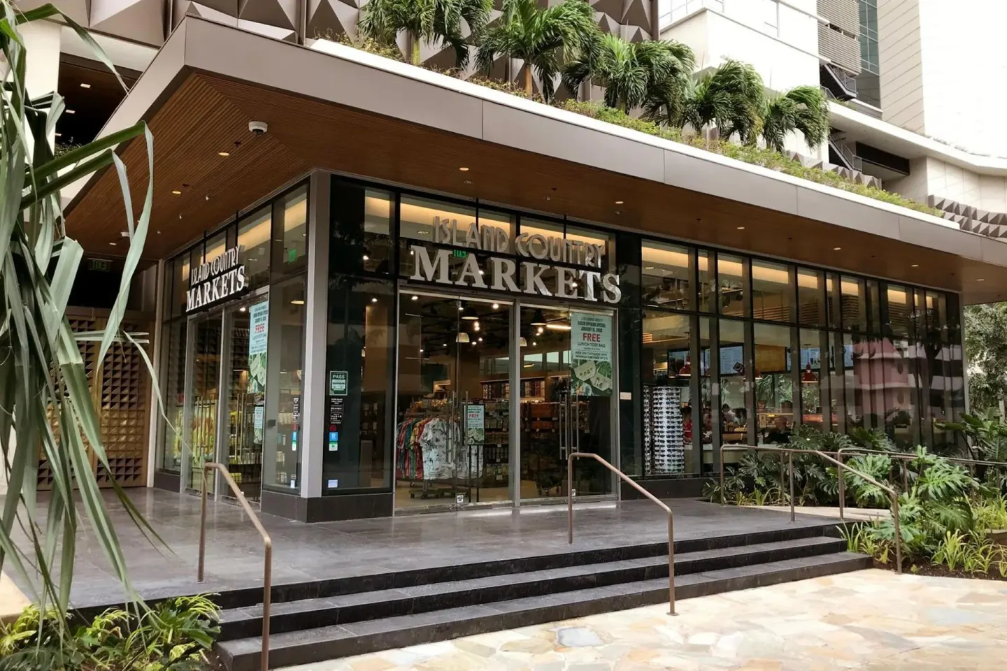 Street-level market entrance at The Ritz-Carlton Residences, Waikiki Beach with glass storefront.
