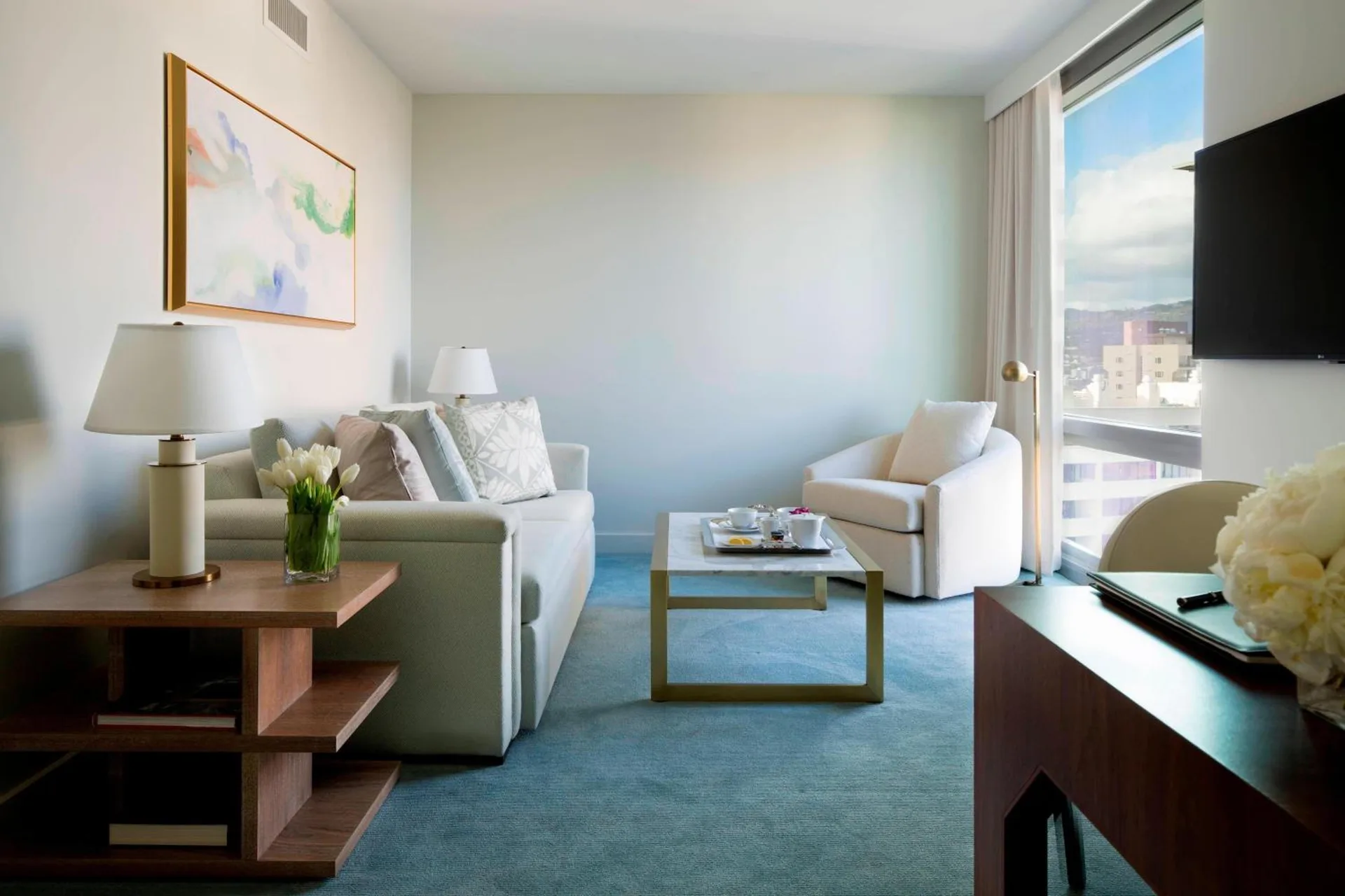 Suite living room with sofa and city view at The Ritz-Carlton Residences, Waikiki Beach.
