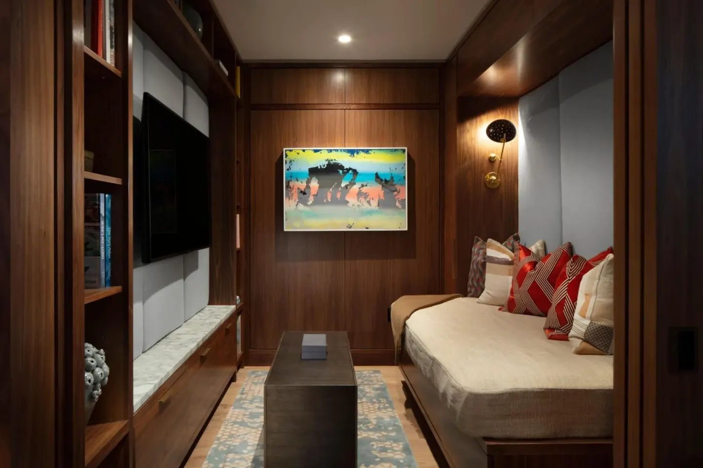 Wood-paneled media room with daybed seating at The Ritz-Carlton Residences, Waikiki Beach.